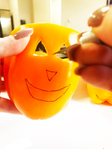 cutting face out of jack o lantern pepper 