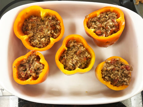 jack o lantern stuffed peppers in baker ready to go into oven