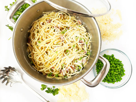 linguini in with cream sauce in pot with pasta fork