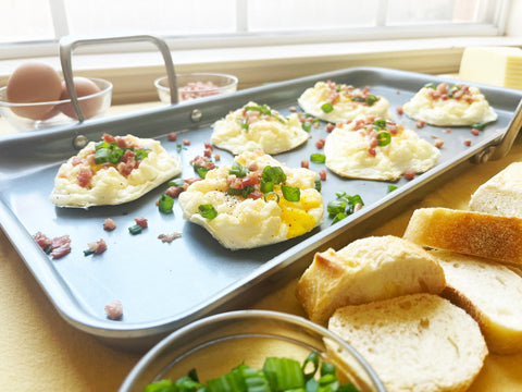 cloud eggs with pancetta and green onions on nonstick griddle