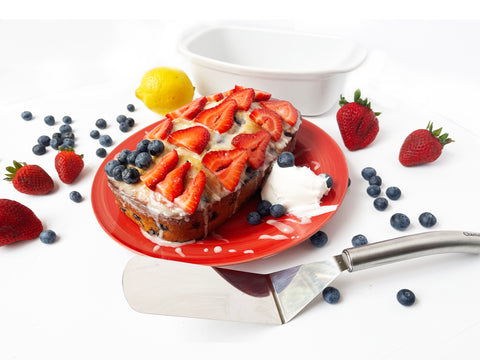 blueberry bread on red plate topped with strawberries