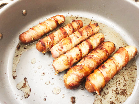 fried hot dogs wrapped in bacon in induction 21 steel ceramic coated 12 1/2 inch fry pan