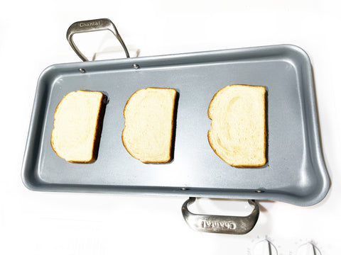 lay out 3 slices of bread on non-stick griddle
