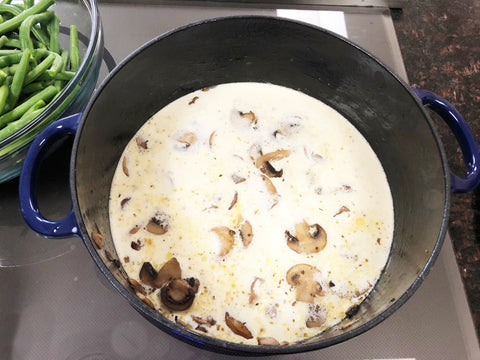 add cream to mushrooms in dutch oven for green bean casserole