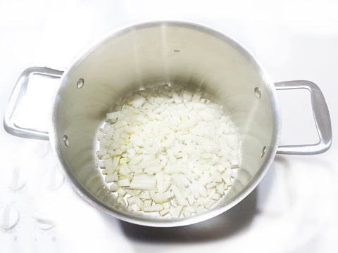 chopped onions and garlic in 3 clad tri ply 7 quart stockpot