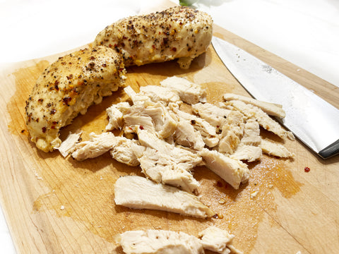 slicing chicken for chicken and feta pasta in medium rectangular baker glacier blue