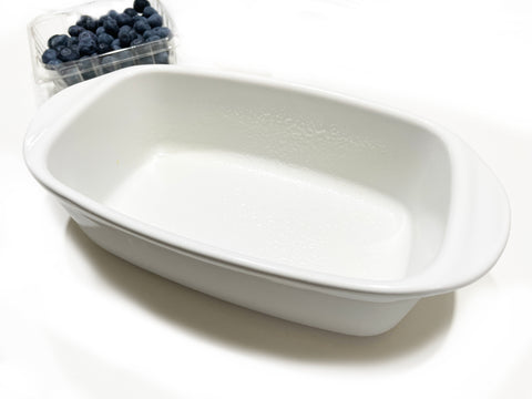 white ceramic load pan greased with butter