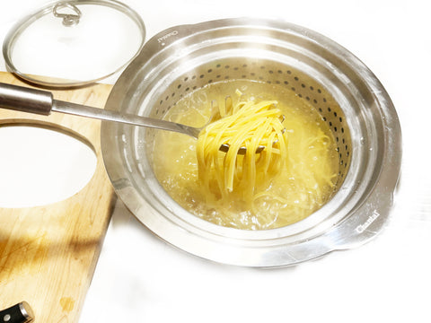 cooked pasta in strainer