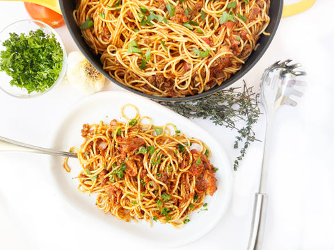 plated beef beer and bacon spaghetti prepared in cast iron dutch and cast iron saute skillet with lid