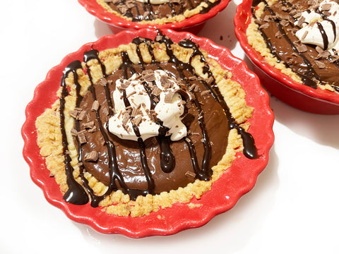 chocolate syrup on top of pie dishes