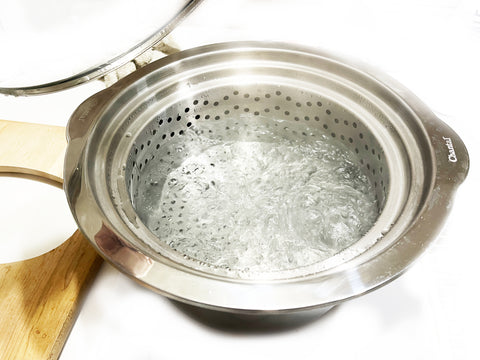 water boiling in induction 21 stainless steel pot with steamer insert