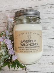Image shows a jar candle with a label that reads "Lavender + Wild Honey"