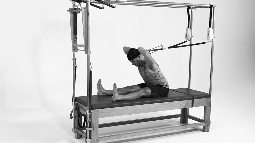 Gratz Gallery | Benjamin Degenhardt using the Neck Stretcher For Spine Stretch on the Cadillac 