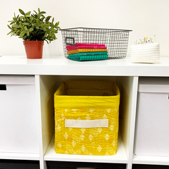 DIY Fabric Storage Cube shown in cube shelves