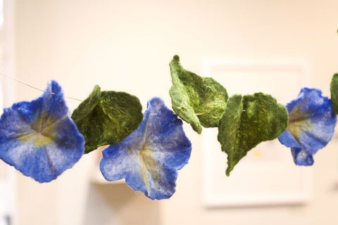 Wet felted morning glory flowers. These are wet felted on a flat surface and are then shaped while wet and set out to dry.