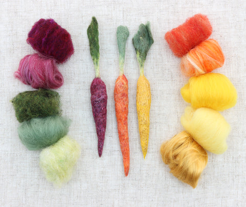 Wet felted rainbow carrots. These are made of unspun wool and silk and are wet felted into three-dimensional carrots.