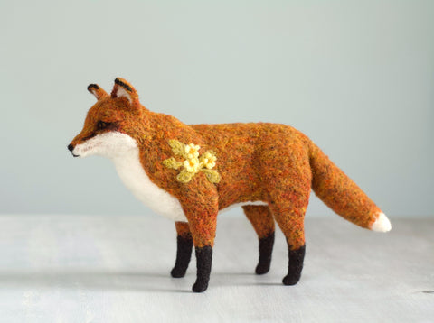 needle felted red fox with felted primroses embellishing surface