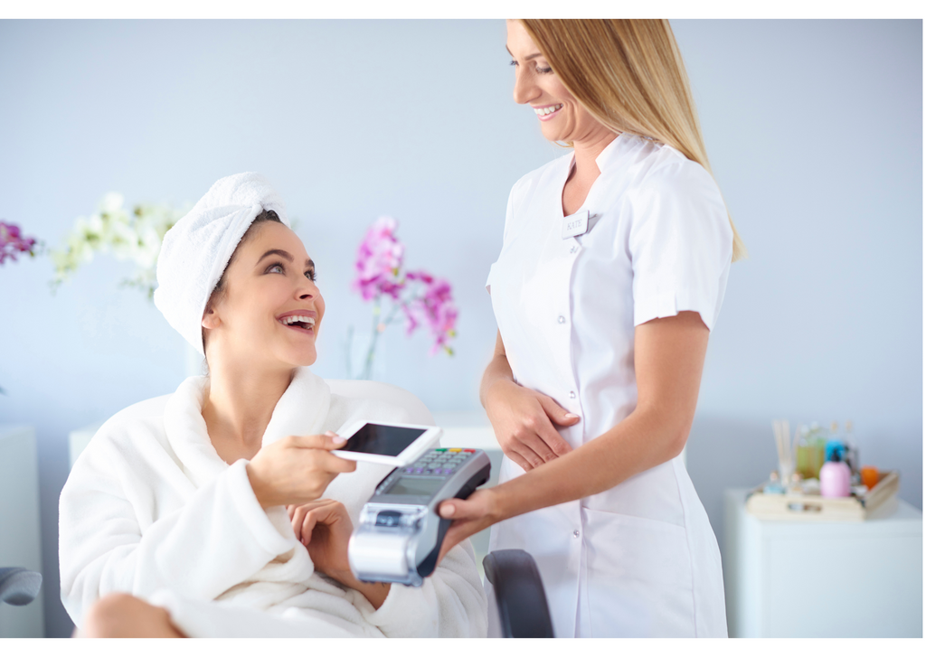 Spa staff converses with female relaxed cliet