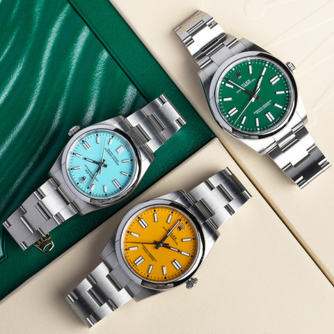 Three Rolex Oyster Perpetual watches in a flat lay