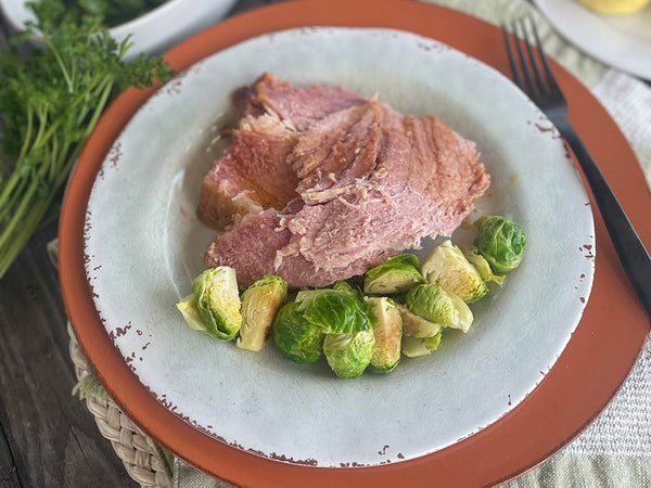 plate of mustard glazed ham and Brussels sprouts