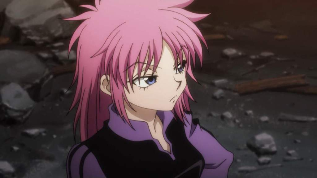 Machi is looking annoyed; one of her hands is on her hip.