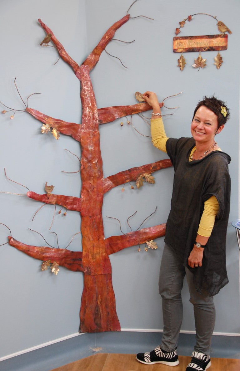 Sharon Mcswiney with metal tree at Mount Edgcumbe Hospice