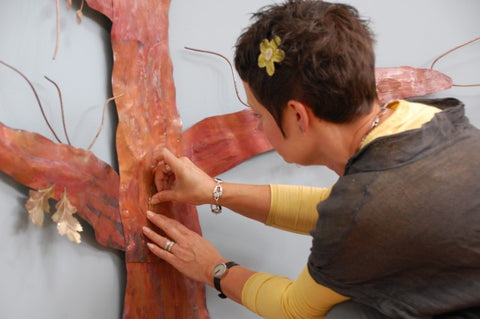 Sharon Mcswiney with a copper tree commission at Mount Edgcumbe hospice