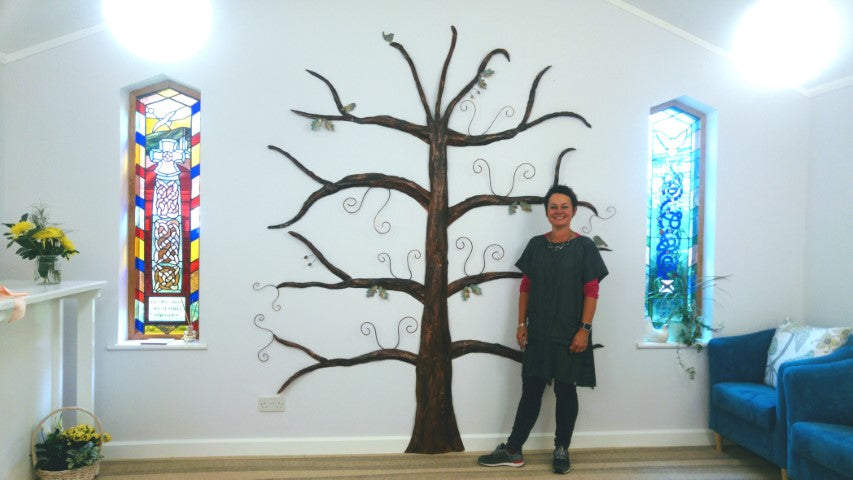 Sharon McSwiney with her handmade metal memory tree at St Julia's Hospice in Hayle