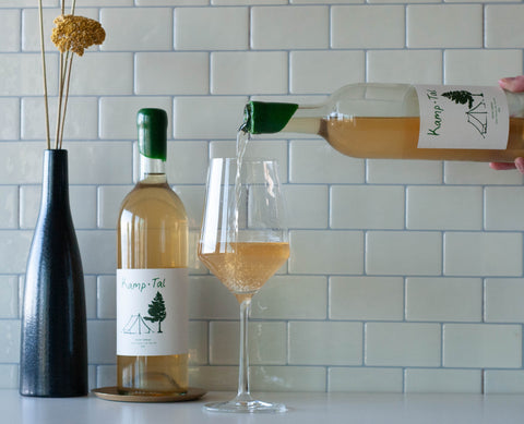 A bottle of Kamp Tal Gruner veltliner being poured into a wine glass