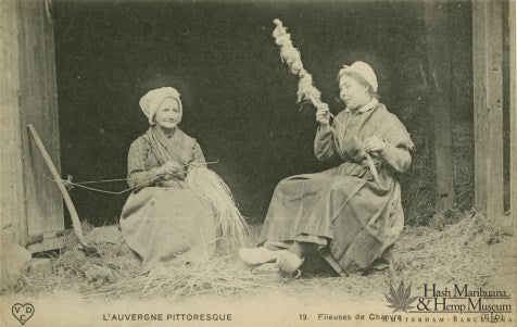 Old photo of two older women weaving cannabis fibres into textiles.