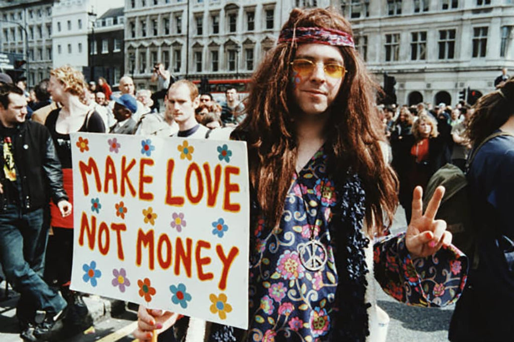 Make love not money sign being carried by a hippie protesting in the 80s.