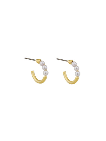 one pair of minimalist gold huggie earrings with a three pearl stack