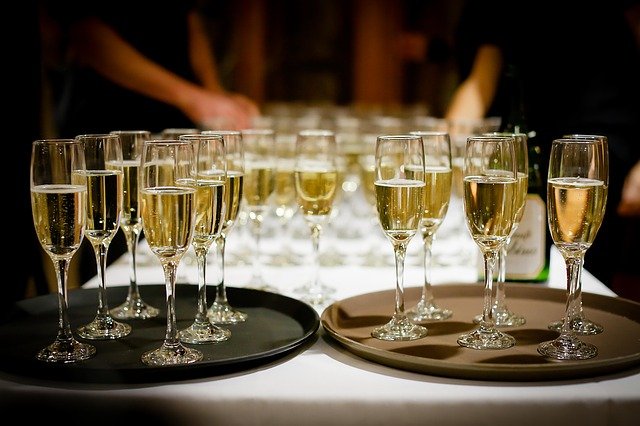 A table filled with flutes of champagne