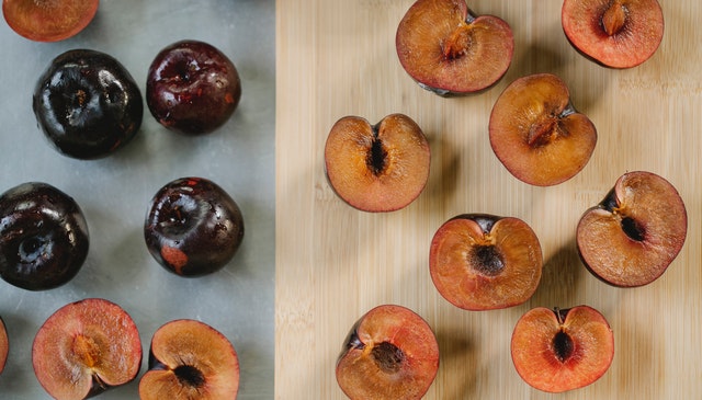 Plums with pits sliced in half