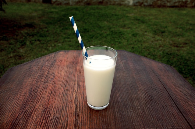 Glass of milk with a straw