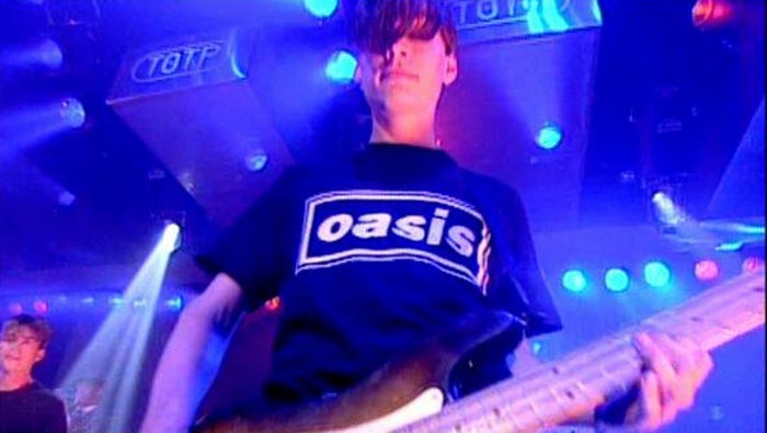 Alex_James_Blur_wearing_Oasis_T-Shirt.jpg