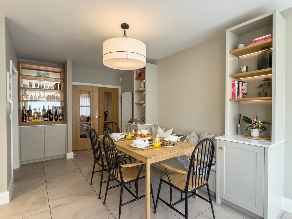 Open plan kitchen diner featuring a built in bar unit with mirrored backs | Ivywell Interiors | Stoke Bishop, Bristol