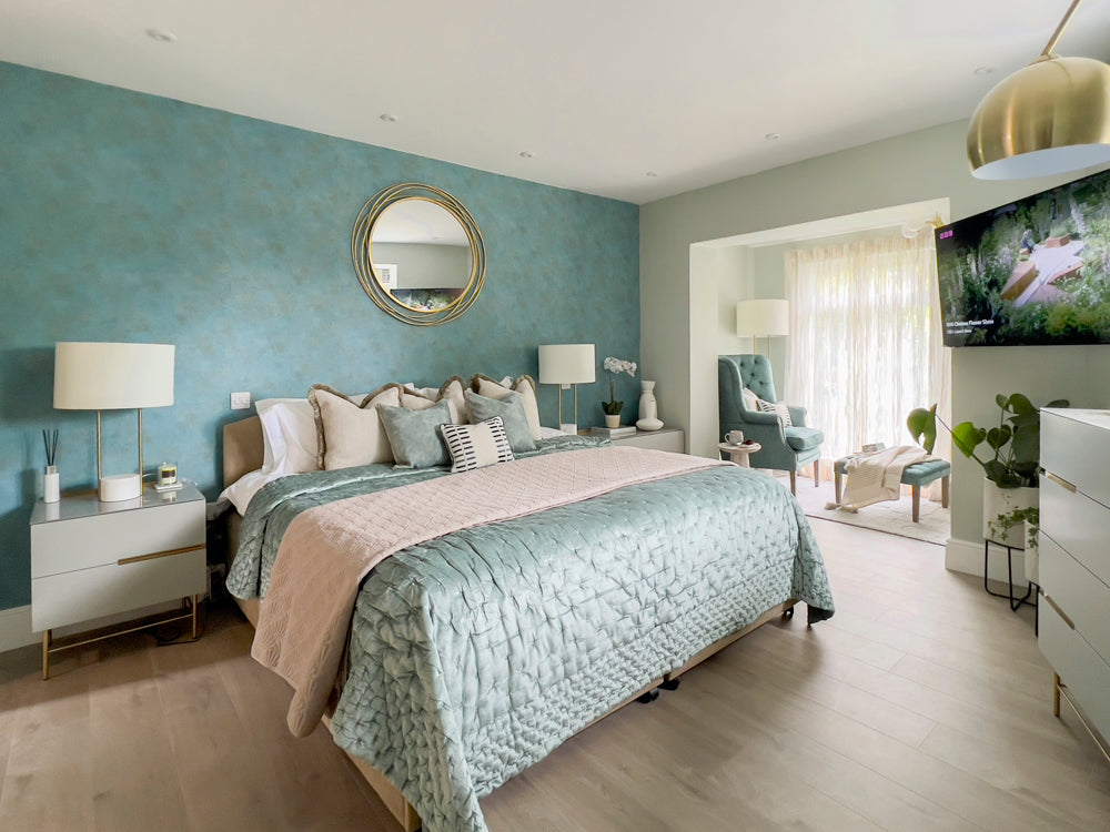 Master bedroom design featuring a reading nook with tones of blues and accents of gold. 