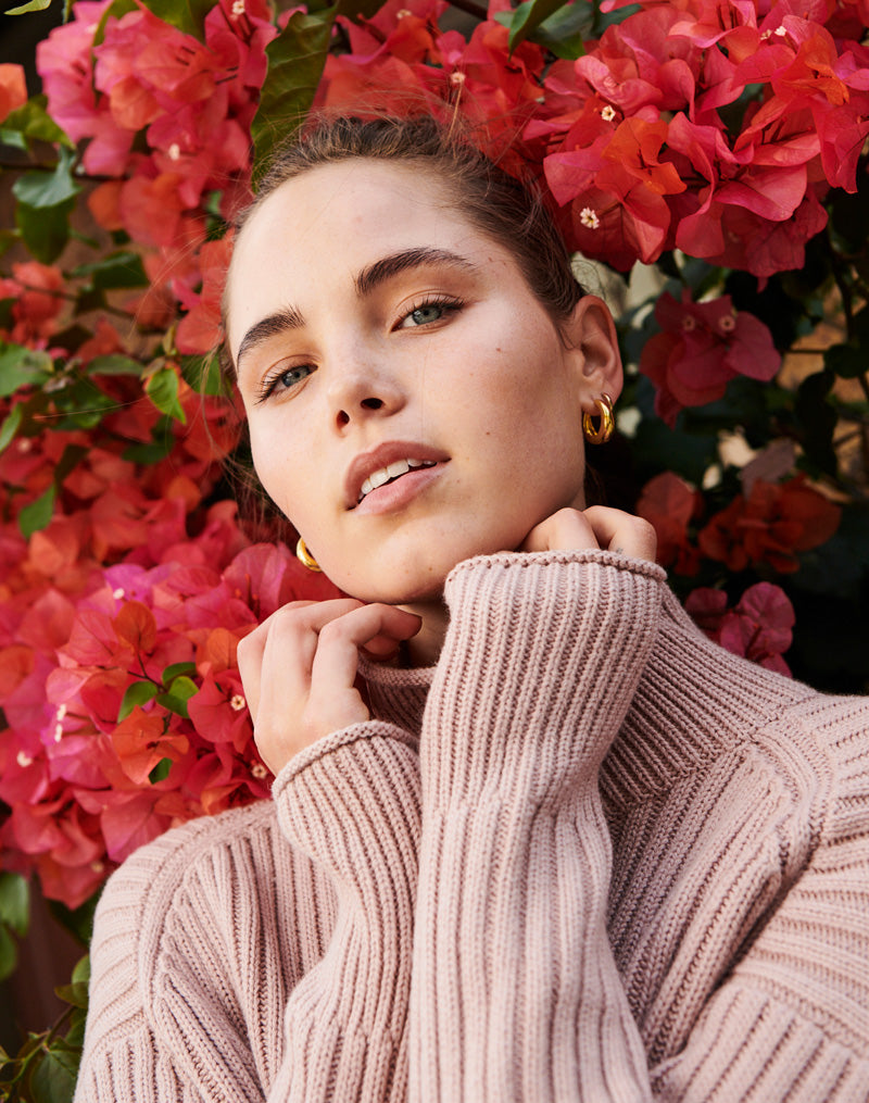 Emma wears the Lou Ribbed Turtleneck in Pink
