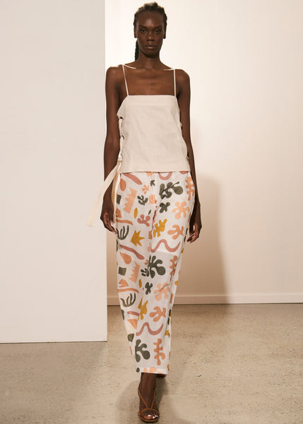 Akelo wears the Nova Tie Cami in Ivory with the Esti Wide Leg Pant.