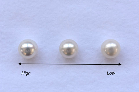 Three pearls displayed in varying sizes, showcasing a change in luster.