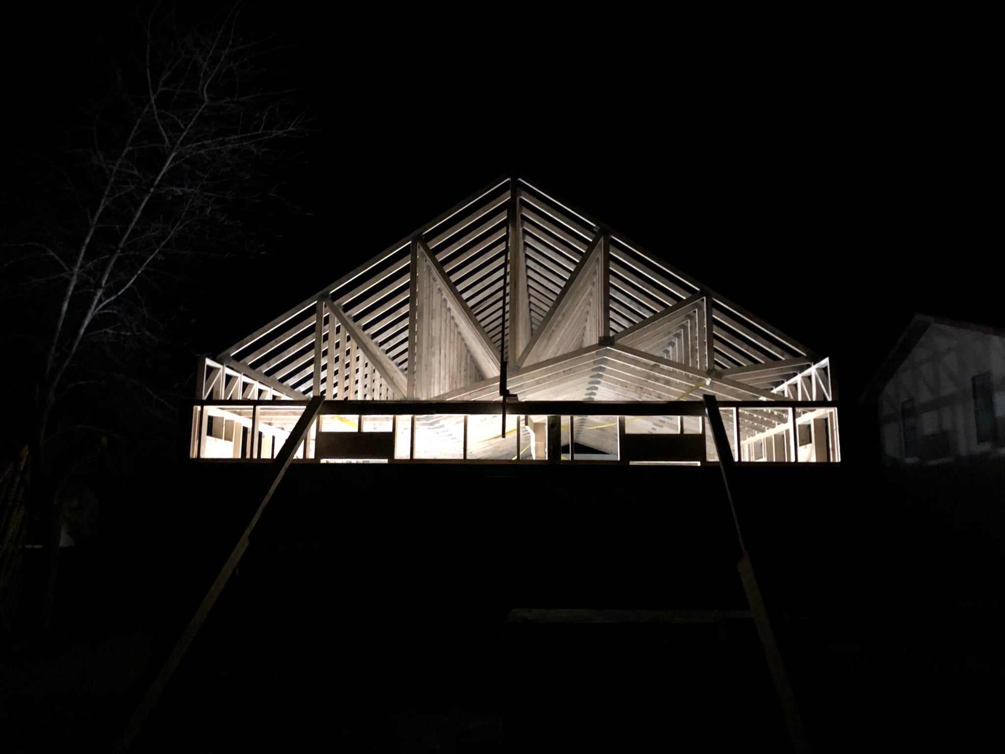 Trusses of DIY home at night