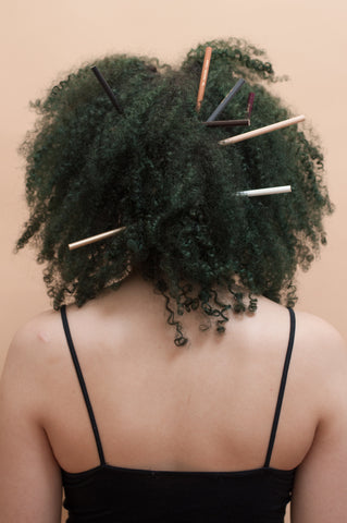 Back shot of afro hair recreating the pencil test