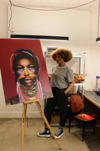 Artist Caroline Chinakwe posing next to A1 Dibond aluminium print of mixed media artwork titled Soul