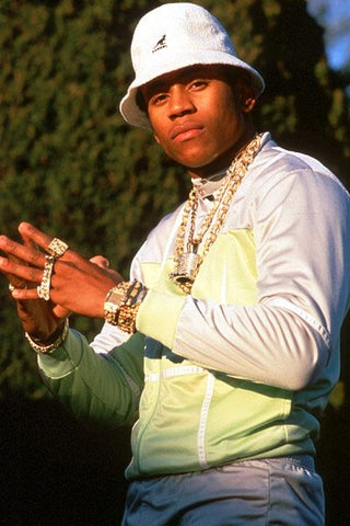 LL Cool J posing wearing a bucket hut, gold jewellery and casual clothing