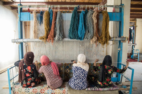 Afghan women weaving rugs