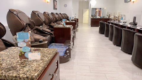 inside nail salon with brown pedicure chairs