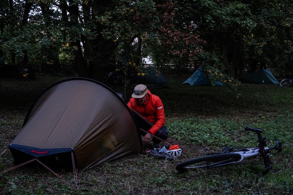 guy building up his bikepacking tent