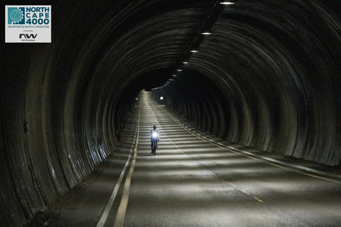 cyclist riding through tunnel alone