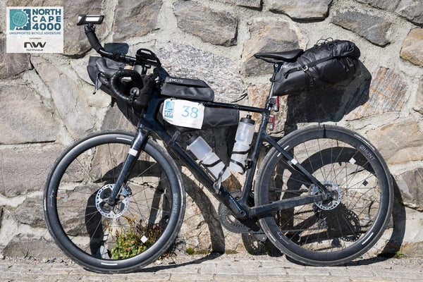 Road Bike with Bikepacking Bags against a wall 